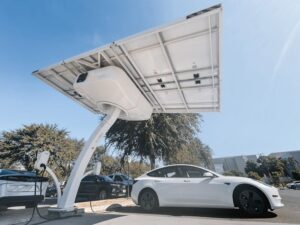 pexels-photo-9800028-9800028 Electric car charging under a modern solar panel station, showcasing clean energy technology.
